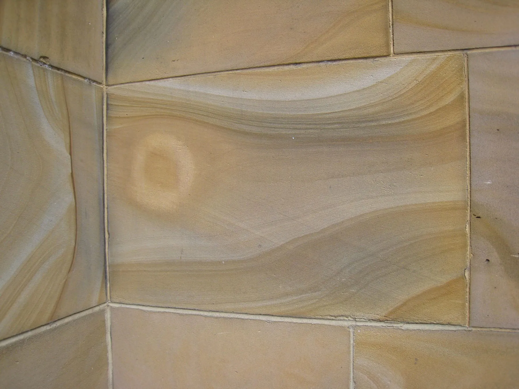 Close material-reference photograph of sandstone ashlar at the University of Melbourne, showing bedding and joints at masonry-block scale.