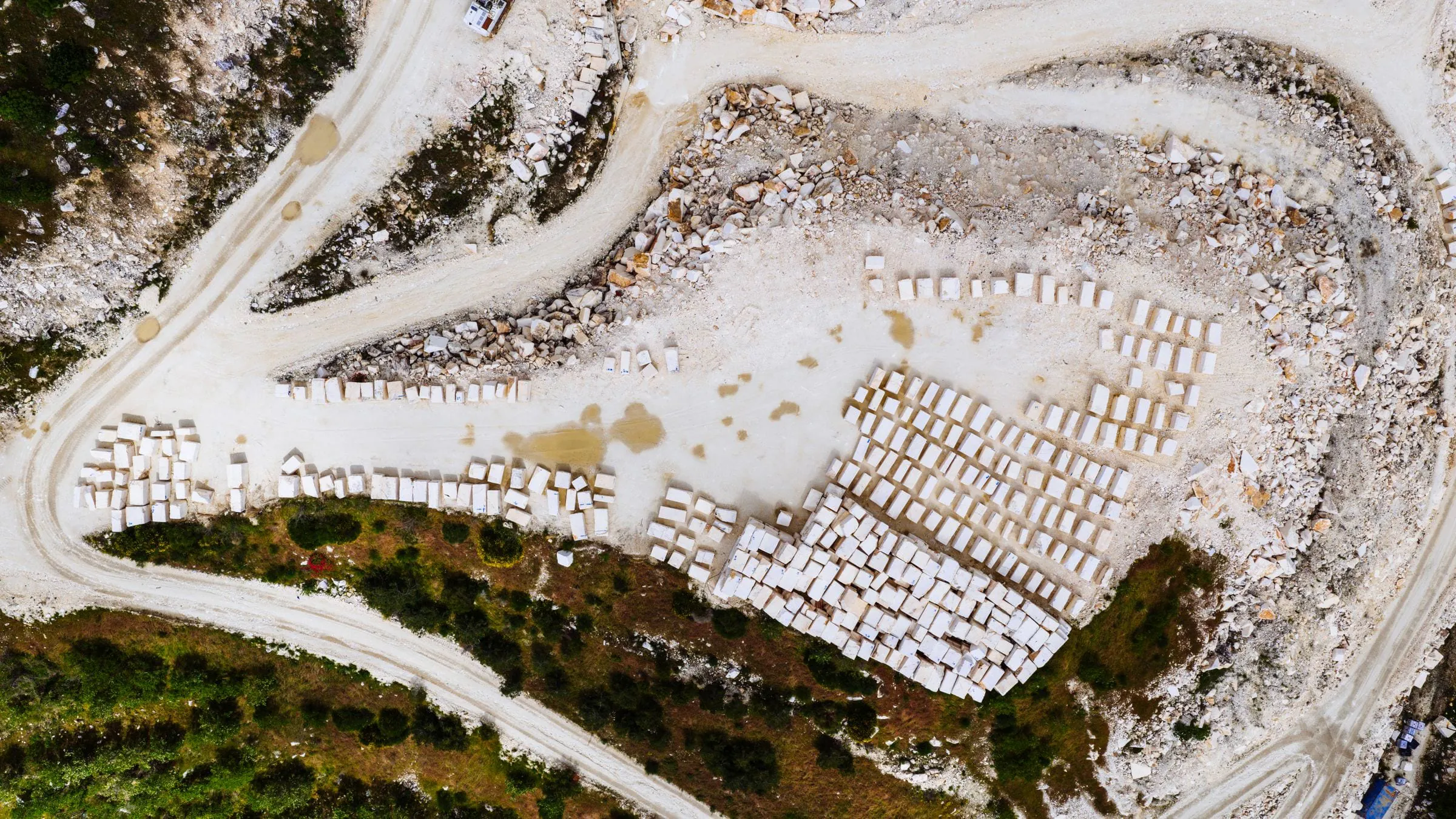 Aerial stock photograph of a marble quarry near Thessaloniki, showing extracted blocks at quarry scale.