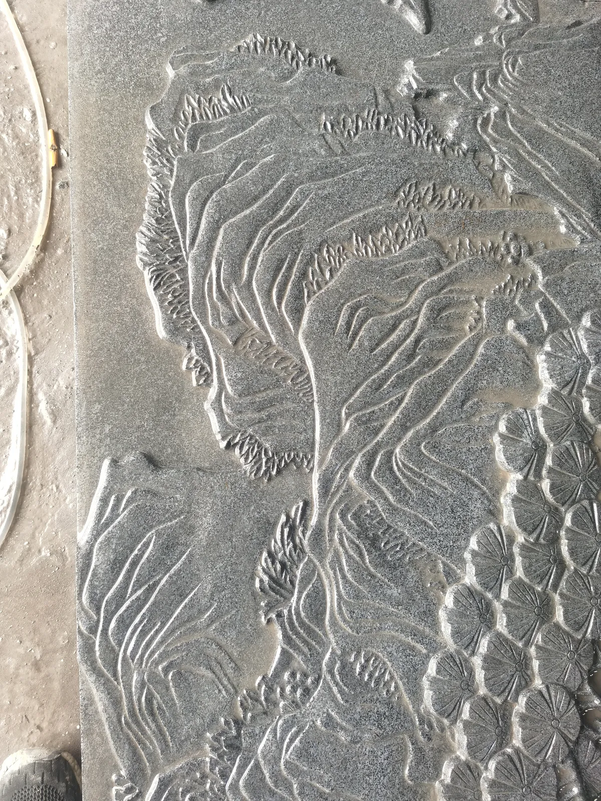 Stone relief of a landscape with receding planes and fine detail.